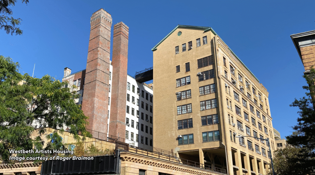Westbeth Artists Housing in NYC, beige multi-story complex with brick chimney | Image courtesy of Roger Braimon